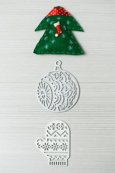 Christmas, new years decor on a wooden white background. Tree, glove, ball.