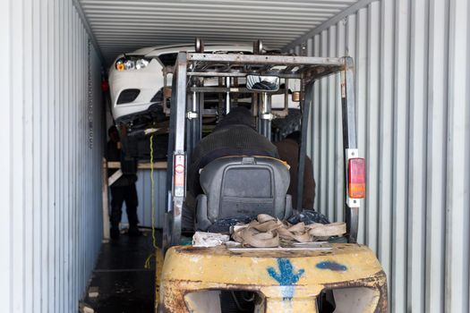 Unloading a broken car from a container
