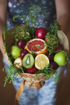 The original unusual edible bouquet of vegetables and fruits in the girl hands