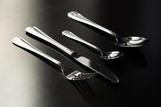 Cutlery on a black background. Fork, spoon knife