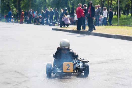 Karting - driver in helmet on kart circuit