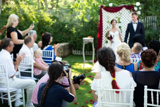 Photographer is a woman photographing a wedding ceremony