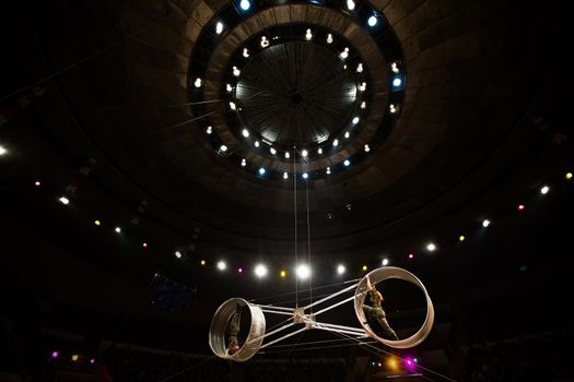 acrobats in the circus perform a complex trick