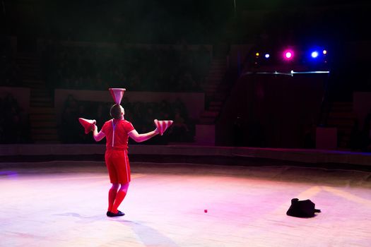 Acrobat performs a difficult trick in the circus.