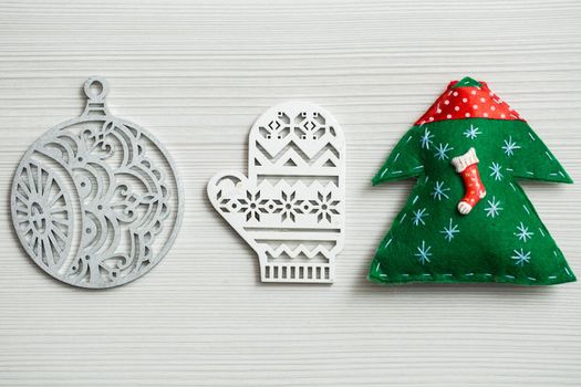 Christmas, new years decor on a wooden white background. Tree, glove, ball.