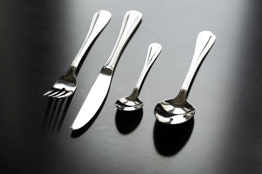 Cutlery on a black background. Fork, spoon knife