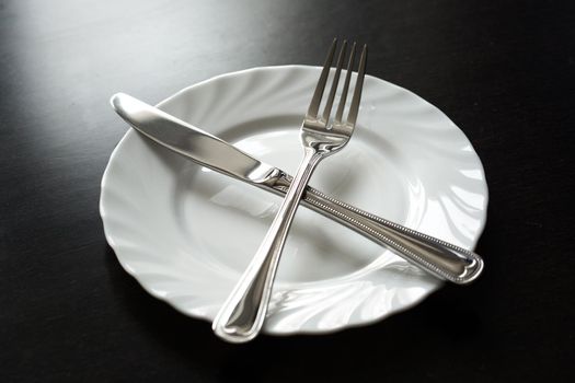 Cutlery on a black background. Fork, spoon, knife plate.