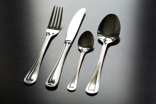 Cutlery on a black background. Fork, spoon knife