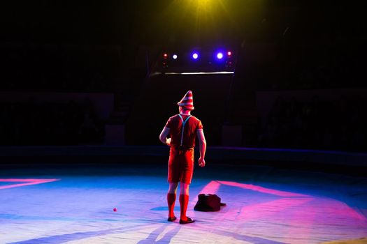 Acrobat performs a difficult trick in the circus.