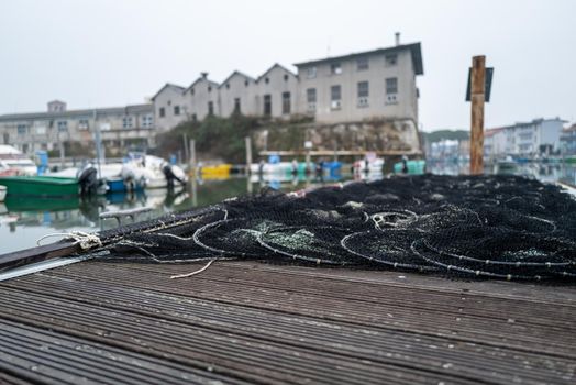 There is a fishing net on a small jetty.