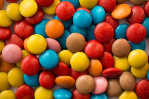 Close up of a pile of colorful chocolate coated candy, chocolate pattern, chocolate background