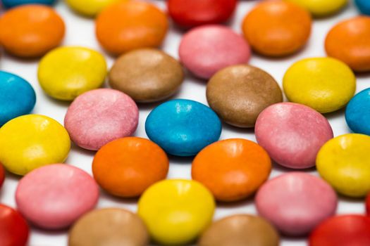 Close up of a pile of colorful chocolate coated candy, chocolate pattern, chocolate background