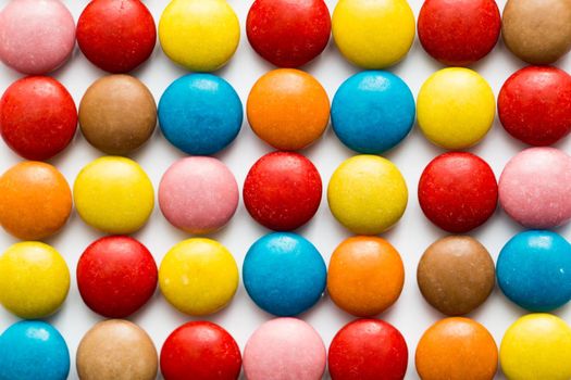 Close up of a pile of colorful chocolate coated candy, chocolate pattern, chocolate background