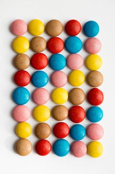 Close up of a pile of colorful chocolate coated candy, chocolate pattern, chocolate background