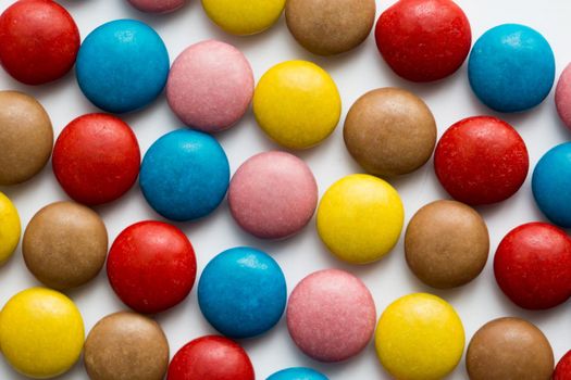 Close up of a pile of colorful chocolate coated candy, chocolate pattern, chocolate background