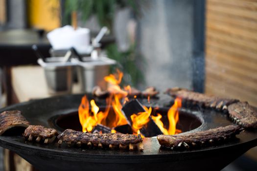 Grilled pork baby ribs with barbecue sauce on the grill. Festival street food