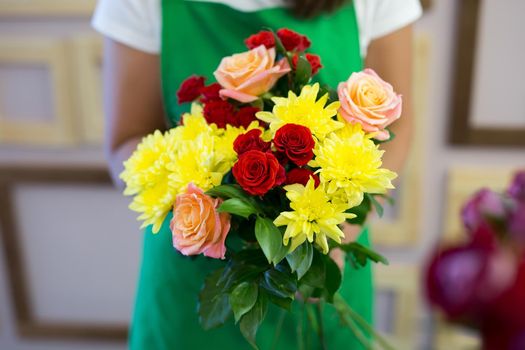 Workshop florist, making bouquets and flower arrangements. Woman collecting a bouquet of flowers