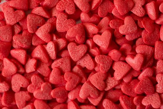 Small red candy hearts, close-up. Macro photography.