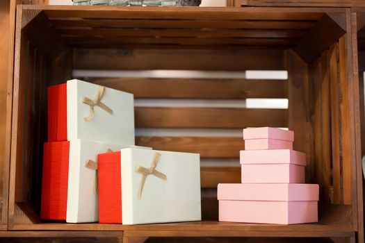 Gift boxes on a wooden background on a showcase