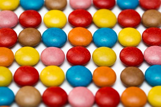 Close up of a pile of colorful chocolate coated candy, chocolate pattern, chocolate background