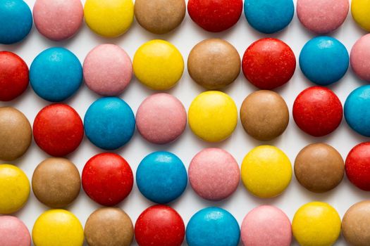 Close up of a pile of colorful chocolate coated candy, chocolate pattern, chocolate background