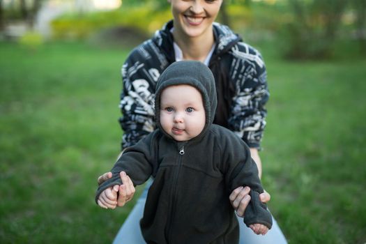 Beautiful Mother And Baby outdoors. Nature. Beauty Mum and her Child playing in Park