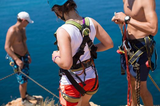 Rope jumping off a cliff with a rope in the water. The ocean. Sea. Mountain.