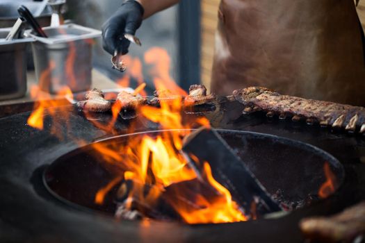 Grilled pork baby ribs with barbecue sauce on the grill. Festival street food