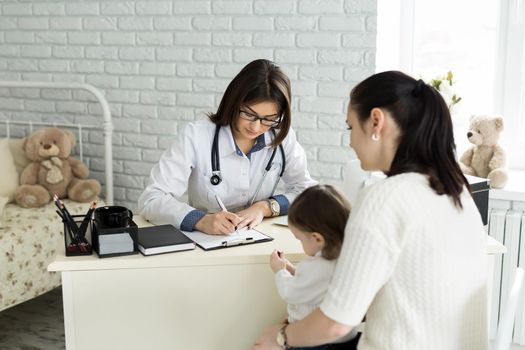 Pediatrician Meeting With Mother And Child In Hospital