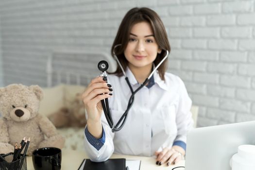Medical doctor woman holding a stethoscope focus on the stethoscope