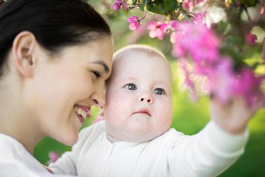 Portrait Beautiful Mother And Baby outdoors. Nature. Beauty Mum and her Child playing in Park