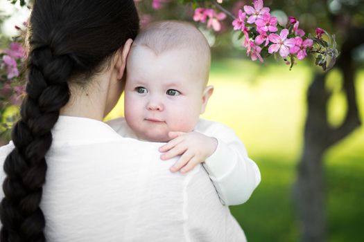 Beautiful Mother And Baby outdoors. Nature. Beauty Mum and her Child playing in Park