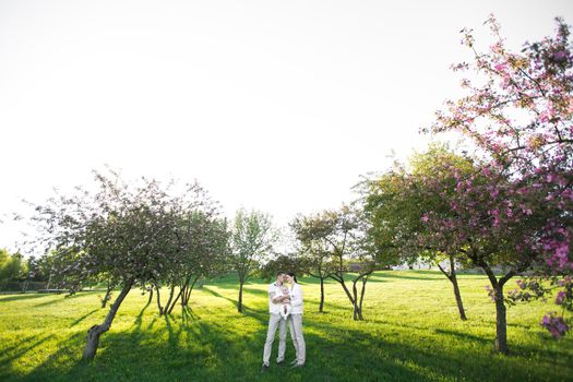 Portrait Beautiful Mother, Father And Baby outdoors. Happy family on a summer meadow