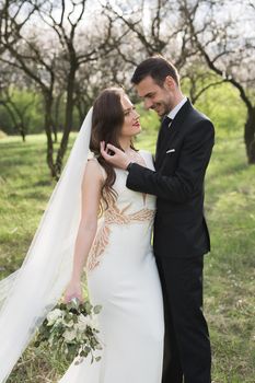 Bride and groom in the green forest