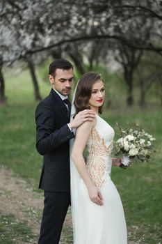 Bride and groom in the green forest