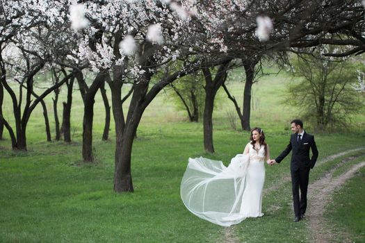 Bride and groom in the green forest