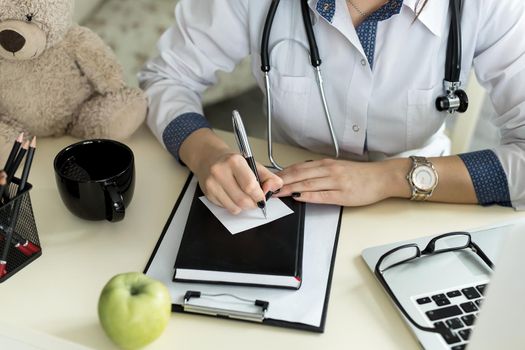 Doctor working in hospital writing a prescription, Healthcare and medical concept