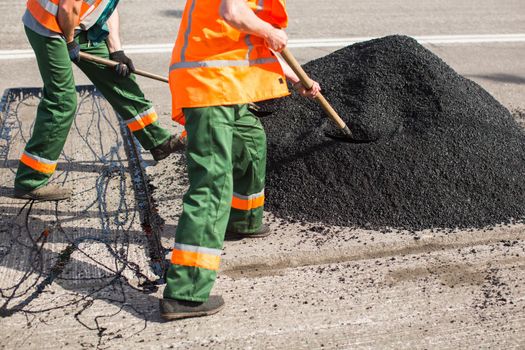 Repair of roads, highways and sidewalks. Patching. Working with a shovel falls asleep in the pit.