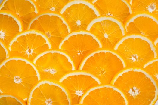 Bright orange background from slices of juicy Orange. Healthy food, background.