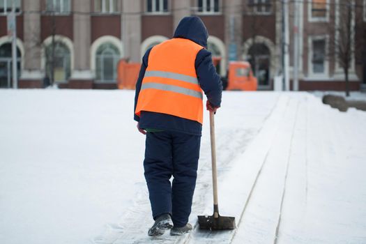 Workers sweep snow from road in winter, Cleaning road from snow storm.