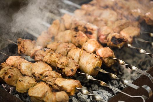 Marinated shashlik preparing on a barbecue grill over charcoal. Shashlik or Shish kebab popular in Eastern Europe. Shashlyk skewered meat was originally made of lamb. Roast Beef Kebabs On BBQ Grill