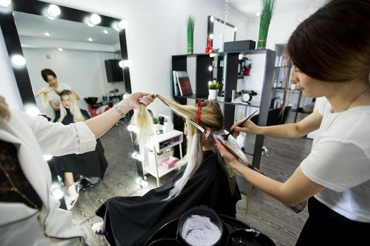 Blonde woman dying her hair at the beauty salon