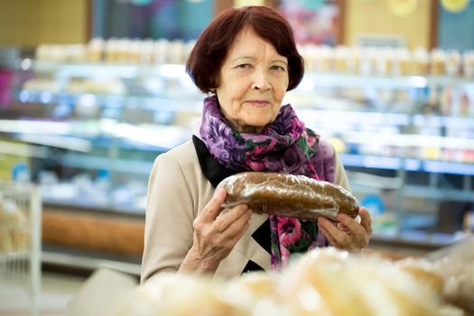 Grandma, woman during shopping bread at supermarket store shop