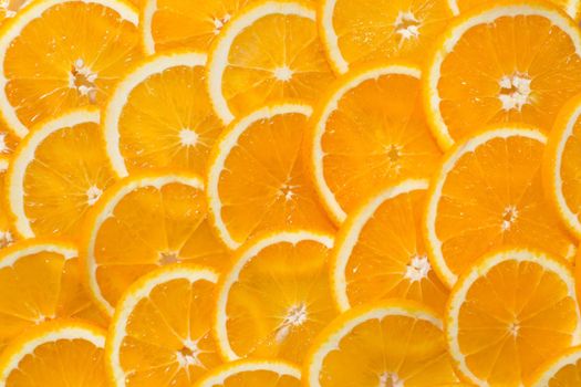 Bright orange background from slices of juicy Orange. Healthy food, background.