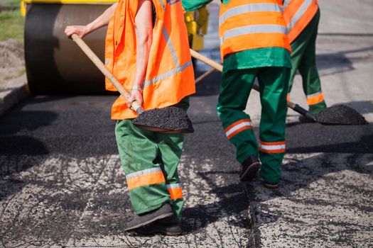 Repair of roads, highways and sidewalks. Patching. Working with a shovel falls asleep in the pit.