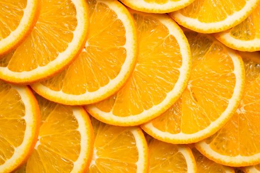 Bright orange background from slices of juicy Orange. Healthy food, background.