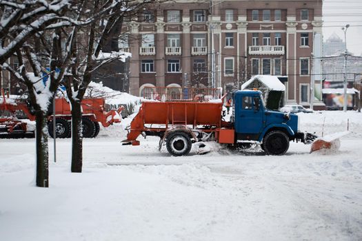 A snowplow that removes snow from a city road