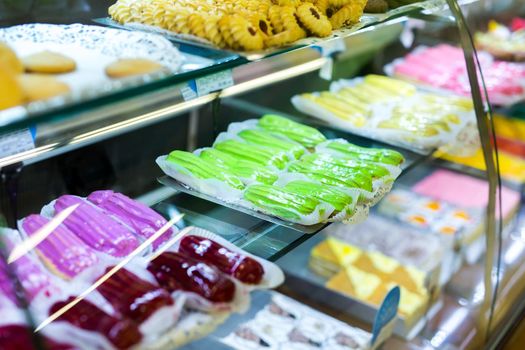 Pastry shop with variety of donuts, muffins, creme brulee, cakes in the supermarket