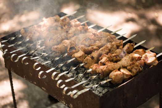 Marinated shashlik preparing on a barbecue grill over charcoal. Shashlik or Shish kebab popular in Eastern Europe. Shashlyk skewered meat was originally made of lamb. Roast Beef Kebabs On BBQ Grill.