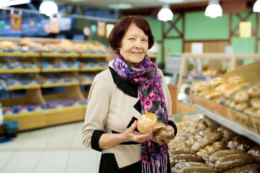 Woman during shopping bread and baguette at supermarket store shop